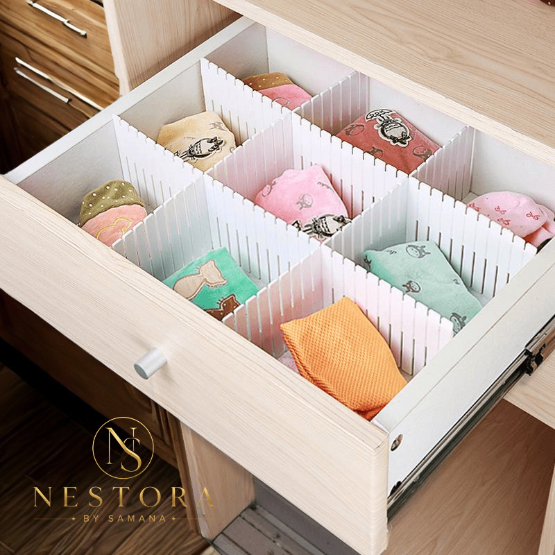 "Adjustable white drawer divider organizer holding folded clothes in wooden dresser drawer"
